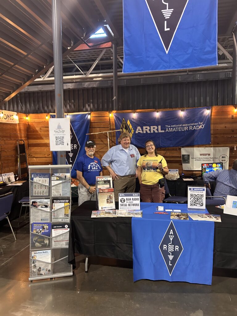 Neil - KL7HQR, Jay - N6SAC, and Virginia - KK6USH ready to greet you at the booth