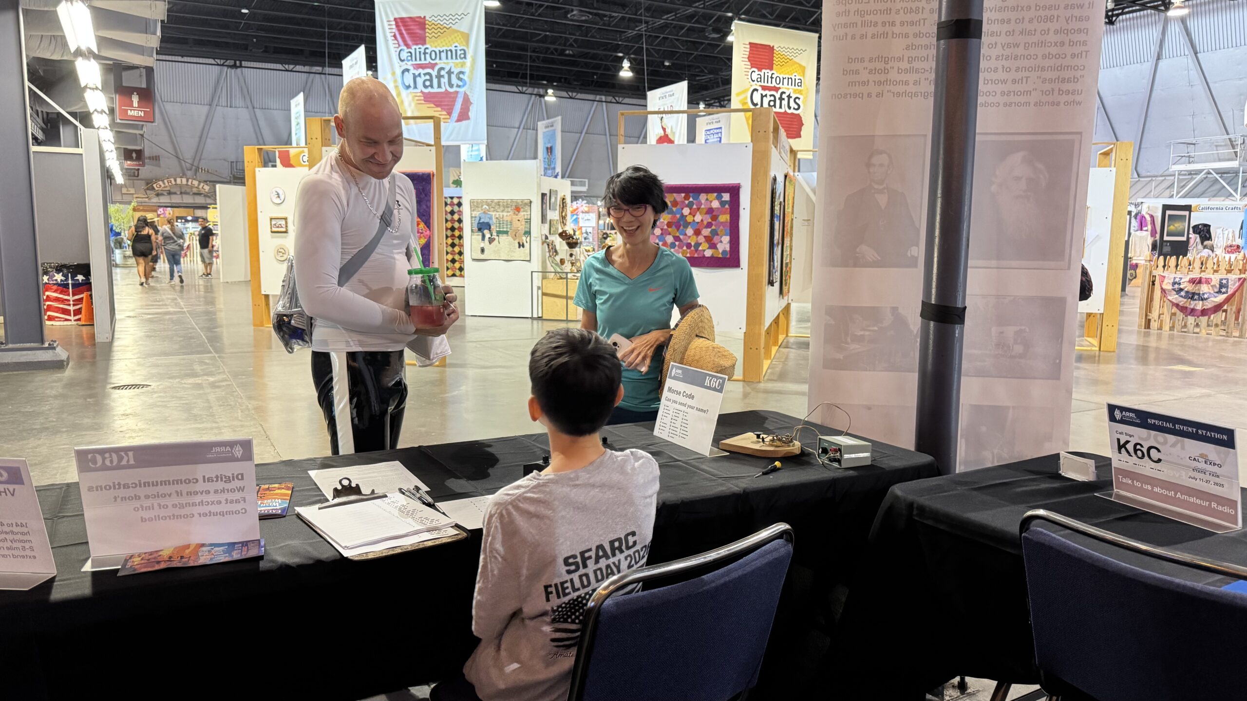 Maxim Graff - KO6NEZ helping a visitor learn Morse Code